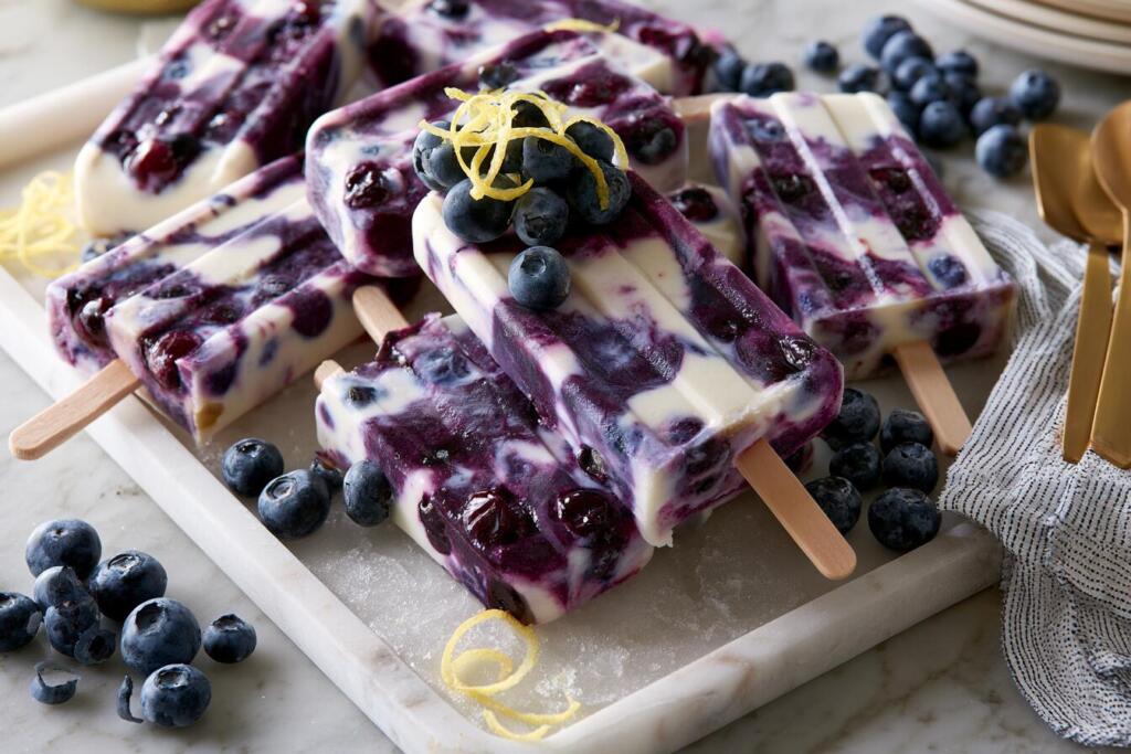 Filled popsicle mold with blueberry protein mixture and sticks before freezing