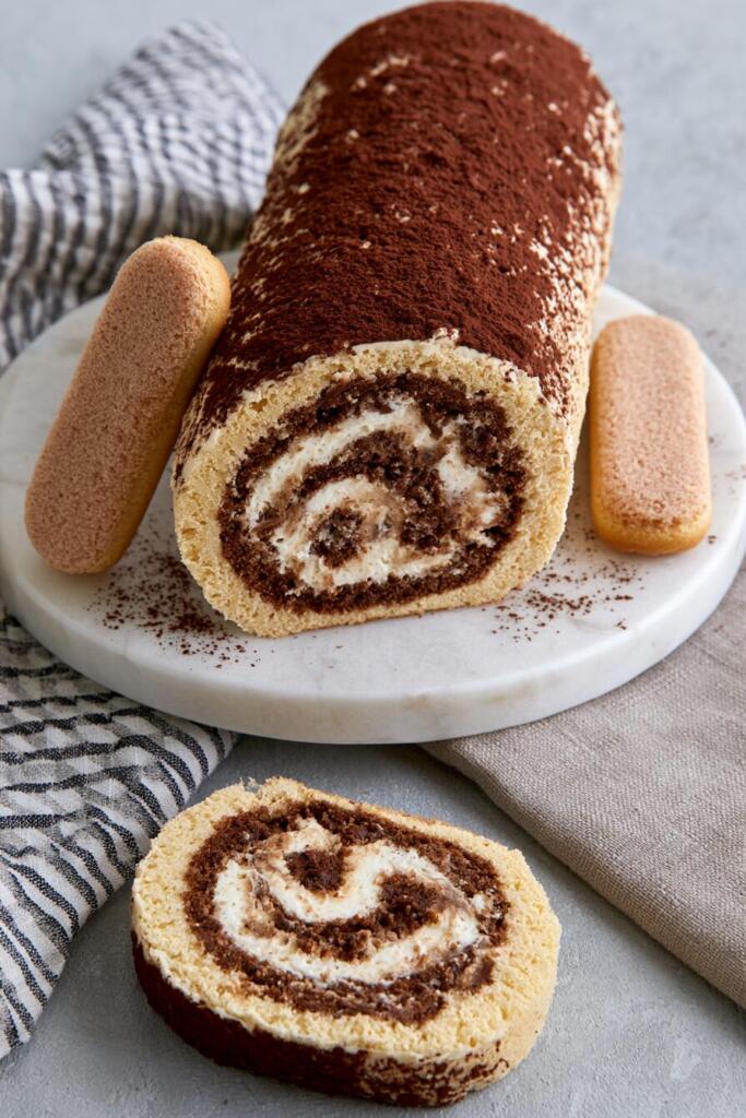 VIRAL tiramisu protein roll cake with spiral cross-section, mascarpone cream and cocoa dusting