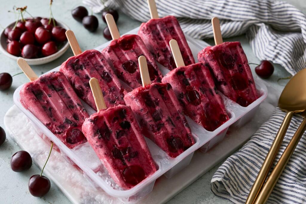 Filled popsicle mold with cherry protein mixture and chocolate flecks before freezing
