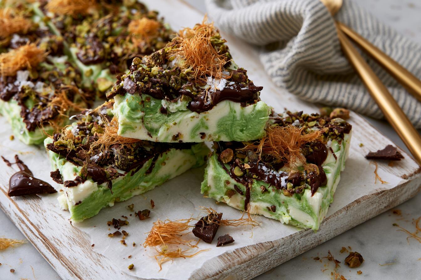 Broken pieces of Dubai chocolate protein bark with pistachio cream swirl, kataifi and dark chocolate drizzle
